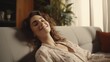 © Muzamil - Happy woman relaxing on the sofa at home - Smiling girl enjoying day off lying on the couch, Healthy life style, good vibes people and new home concept