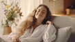 © Muzamil - Happy woman relaxing on the sofa at home - Smiling girl enjoying day off lying on the couch, Healthy life style, good vibes people and new home concept