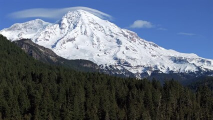 Wall Mural - Majestic Mount Rainier Towering Over Verdant Forest: Aerial Drone View