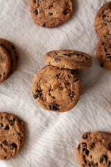 Wall Mural - Homemade Gooey Chocolate Chip Cookies on a white wooden background, top view.