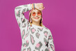 © ViDi Studio - Young fun trendy happy lesbian woman wear pink animal clothes put hand on forehead head look camera posing isolated on plain purple background studio portrait. Pride day June month love LGBTQ concept.