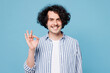 © ViDi Studio - Young satisfied fun smiling happy cheerful man wear shirt white t-shirt casual clothes showing okay ok gesture isolated on plain pastel light blue cyan background studio portrait. Lifestyle concept
