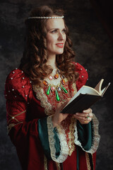 Wall Mural - happy medieval queen in red dress with book