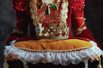 Wall Mural - Closeup on medieval queen in red dress with crown on pillow