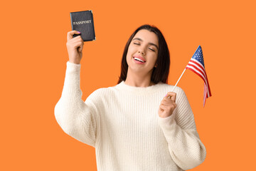 Poster - Beautiful young happy woman with USA flag and passport on orange background