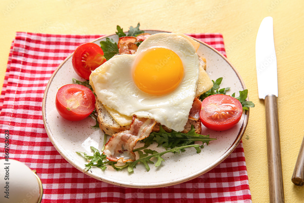 Plate with tasty fried egg, tomatoes and arugula on beige background, closeup