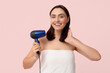 © Pixel-Shot - Beautiful young woman with hair dryer on pink  background