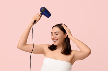 Sticker - Beautiful young woman with hair dryer on pink  background