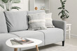 © Pixel-Shot - Grey sofa with stylish cushions in living room