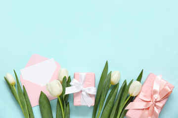 Wall Mural - Envelope with blank card, gift boxes and white tulips on turquoise background