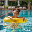 © Ace64 Studio - black overjoyed laughing smiling exited child in swimming pool floating on swimming ring, Little girl having fun on family summer vacation in tropical hotel resort, tourism