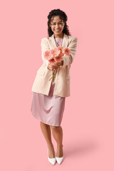 Poster - Beautiful young African-American woman with bouquet of gerbera flowers on pink background. International Women's Day