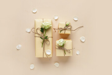 Wall Mural - Gift boxes with beautiful white roses and petals on beige background. International Women's Day