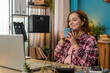 © Andrii Iemelianenko - Young Caucasian businesswoman working on laptop computer drinking cup of warm hot coffee sits at table workplace home office room in the morning. Female freelancer enjoying relaxing, taking a break.