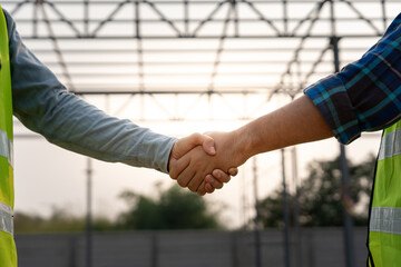 Wall Mural - Construction team hands shaking greeting start up plan new project contract in office center at construction site, industry ,architecture, partner, teamwork, agreement, property, contacts.