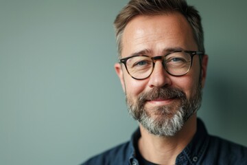 Poster - Portrait of a handsome mature man with grey beard and glasses.