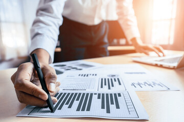 Wall Mural - Businessman accountant or financial expert analyze business report graph and finance chart at corporate office. Concept of finance economy, banking business and stock market research. uds