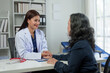 © crizzystudio - An Asian female doctor explains and encourages the struggle of life to a retired female patient who comes for treatment and therapy at a private clinic. Health concept, health insurance.