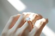 © Jiraphat - Closeup of a Diamond Engagement Ring on a Finger in Natural Sunlight