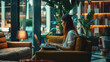 © Jaroon - A woman is sitting at a table with a laptop, creating a pleasant and relaxing atmosphere.
