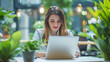 © Jaroon - A woman is sitting at a table with a laptop, creating a pleasant and relaxing atmosphere.