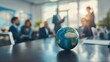 © Sourav Mittal - Photo of business team meeting with a globe on the table in an office, focusing on the planet Earth and blurred people at work during a conference or group business training for travel company ideas c