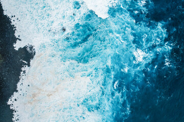 Aerial view of rough ocean with waves and volcanic beach, porto Moniz Madeira, Portugal