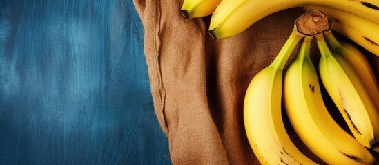 Ripe banana with brown stains in a rear jeans pocket, creating a lifestyle fruit background with denim and a copy space image.