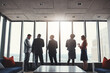 © Reese Coop/peopleimages.com - Business people, discussion and standing by window in boardroom with city view for career in real estate. Men, woman and conversation on property management, investors and corporate professionals.