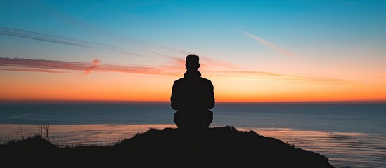 Aufkleber - Silhouette of human in the distance against the background of the sky and the sea at sunset. Copy space image. Place for adding text or design