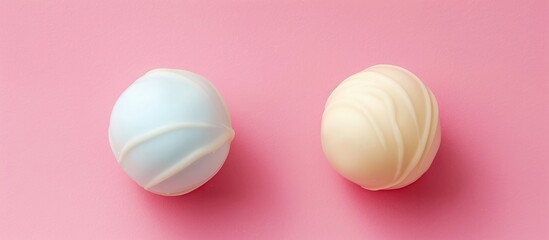 Poster - White chocolate candy ball isolated over the pastel background, set of two different foreshortenings. with copy space image. Place for adding text or design
