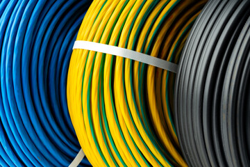 Three Rolls of Electrical Wire in Blue, Yellow and Green, and Black Colors