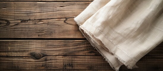 Wall Mural - Tablecloth textile on wooden background. Copy space image. Place for adding text or design