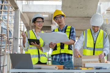 Wall Mural - Group architect team on construction site inspection documents and business workflow in the morning.