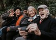 © Rawpixel.com - Senior friends taking selfie at a park bench