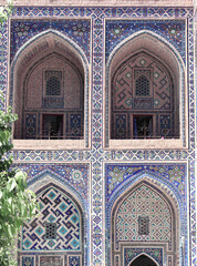 Poster - Famous landmark - Ulugh Beg Madrasah on Registan square, Samarkand, Uzbekistan. Arches with tile ornament in the courtyard of Ulugh Beg Madrasa