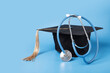 © yta - Medical education, graduation cap and doctor's stethoscope, graduate with diploma celebrating academic achievement, university ceremony with health professionals