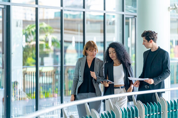 Group of Diversity businessman and businesswoman colleague working and discussion business project together outside office building. Business people teamwork meeting corporate business in the city.