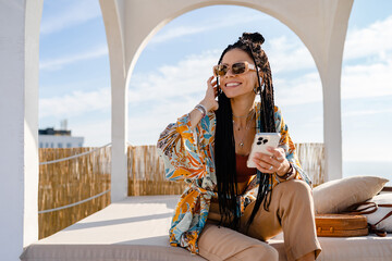 Wall Mural - stylish pretty woman with african braids on sunny summer vacation