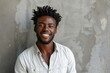 © CogniLens - Portrait of a tender afro-american man in his 20s smiling at the camera in plain cyclorama studio wall