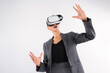 © InfiniteFlow - Business woman holding something while wearing VR goggle and standing at white background. Project manager with headset enter visual reality world program by using technology innovation. Contraption.