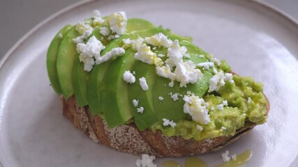 Wall Mural - Avocado toast with feta and pistachio on plate.