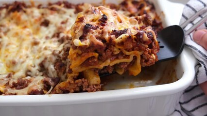 Wall Mural - Traditional meat lasagna in a white baking dish.