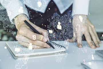 Wall Mural - double exposure of social network icons concept with world map and hand writing in notepad on backgr