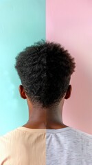 Wall Mural - A man with an afro stands in front of a teal and pink wall