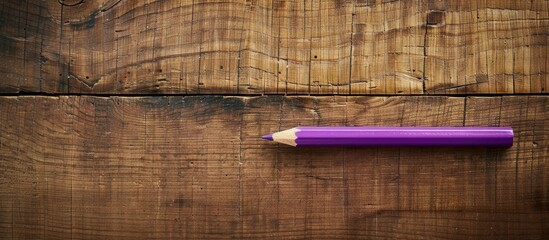Aufkleber - An aerial shot of a purple pencil and paperclip on a wooden backdrop with space for an image. copy space available