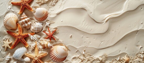 Poster - Flat lay arrangement featuring lovely starfish and seashells on sandy beach with copy space image.