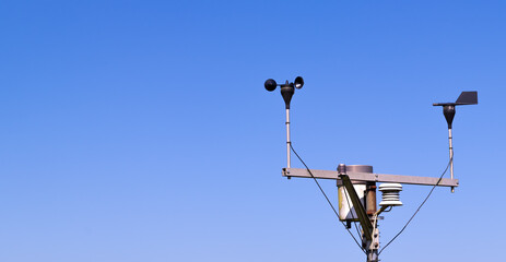 close-up of an anemometer for measuring wind speed, a small weather station. anemometer on a blue sk