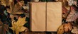 © meristock - Brown craft paper sheet and autumn leaves provide the backdrop for a diary in this copy space image, ideal for text placement.