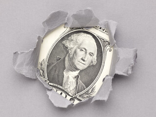 us dollar in the hole of grey paper